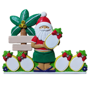 A colorful Christmas-themed decorative table top ornament featuring a Santa Claus figure in a Hawaiian hula outfit, holding a pineapple for personalizing. The design includes a green palm tree with 'HAWAII' on the leaves, two blank photo frames, and pineapple motifs on a white background.