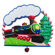 A festive Christmas-themed wall mirror with a black steam train, green Christmas tree, red bell, and candy cane border on a white background.