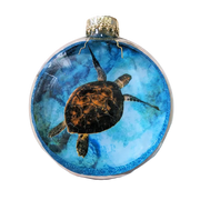 Decorative ornament with a sea turtle design on a blue background