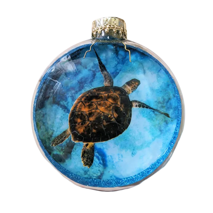 Decorative ornament with a sea turtle design on a blue background