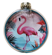 A round clear glass ornament featuring a printed tropical design with a pink flamingo, palm leaves, and a glittery blue border, topped with a gold cap.