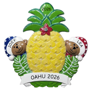 A decorative pineapple-shaped ornament or plaque with green leaves, a yellow textured center, a small red flower on top, and two cartoon bears peeking out from behind green leaves at the sides. A white banner at the bottom reads 'Oahu 2026,' and the top and side names '2026,' 'JOEY,' and 'LEA' are visible.