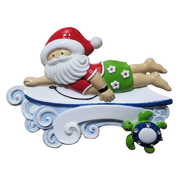 A festive Santa Claus figurine lounging on a white boogie board with blue wave details, accompanied by a small green turtle, isolated on a white background.